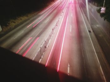 Light trails on road in city at night