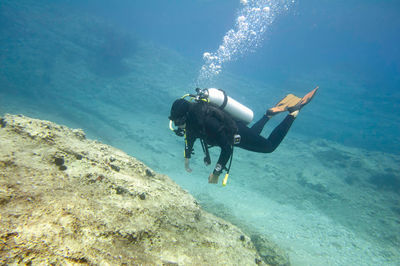 Woman scuba diving in sea