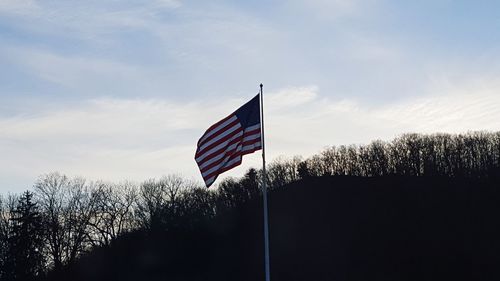 Low angle view of american flag against sky