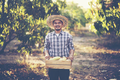 Portrait of smiling man standing on field