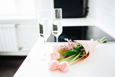 Two glasses and a tulips bouquet, mother's day, holiday at home