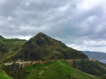 Scenic view of mountain against cloudy sky