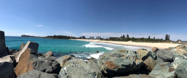 Panoramic view of beach against blue sky