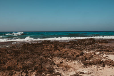 Scenic view of beach against clear sky