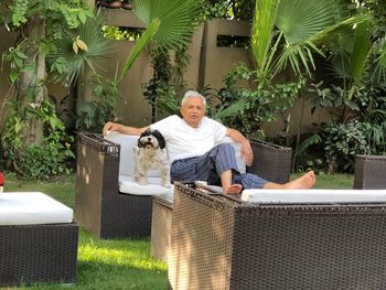 Portrait of man sitting in yard