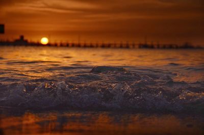 Close-up of sea against sky at sunset