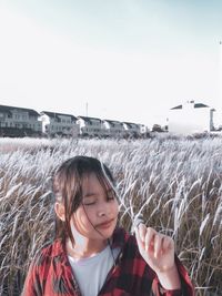 Portrait of girl looking at camera against sky