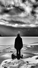 Rear view of man walking on beach