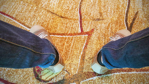 Low section of man standing on carpet