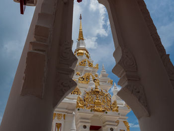 Thai traditional style white pagoda inside the temple with blue sky background.