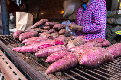 Close-up of sweet potatoes on metal grate in market