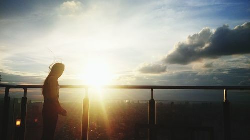 Silhouette woman against sky during sunset