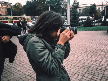 Man photographing on city street