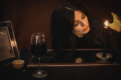 Close-up of woman with drink on table