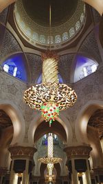 Low angle view of illuminated chandelier in building