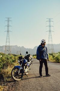 Rear view of man riding bicycles on road