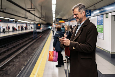 Man standing on railroad station platform