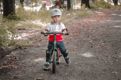 Portrait of cute toddler boy riding a push bike