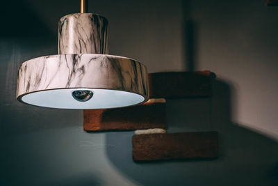 Close-up of electric lamp on table at home