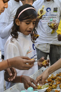 Rear view of people holding ice cream