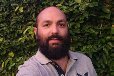 Portrait of bearded man against tree