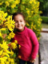 Portrait of smiling woman with yellow flower