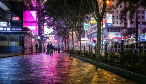 People walking on street in city at night