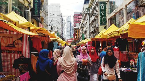 People standing at market in city