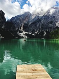 Scenic view of lake by mountains against sky