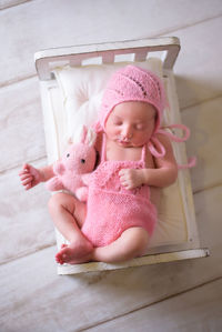 Portrait of cute baby boy sitting on table