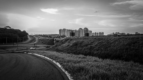 Road amidst buildings against sky in city