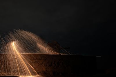 Light trails against sky at night