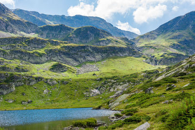 Scenic view of lake and mountains against sky