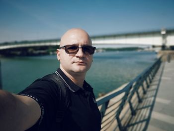 Portrait of young man wearing sunglasses standing outdoors