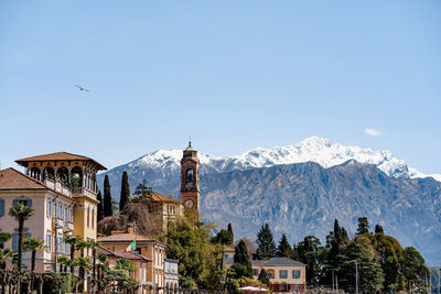 Panoramic view of buildings and mountains against clear sky