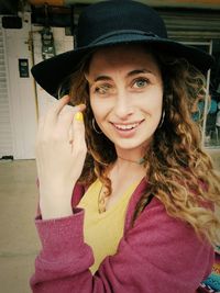 Portrait of smiling young woman in hat