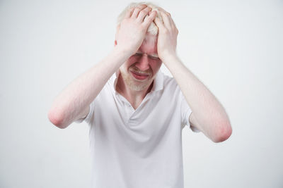Midsection of man wearing hat against white background