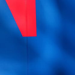 Low angle view of flag against blue wall