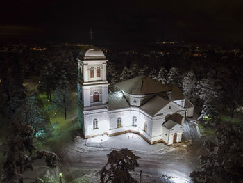 Illuminated buildings against sky at night