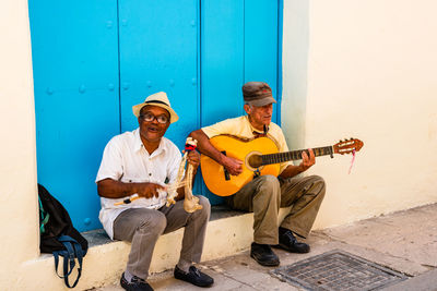 Full length of man playing guitar