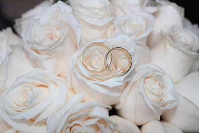 High angle view of rings on white roses