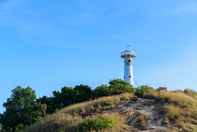 White lighthouse on a cliff at lanta noi island, south of thailand krabi province, landmark 