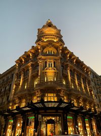 Low angle view of illuminated building against sky