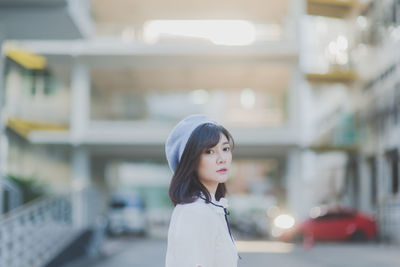 Side view of young woman standing outdoors