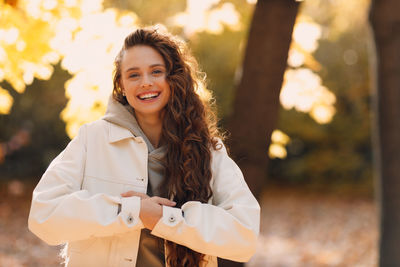 Portrait of young woman standing outdoors