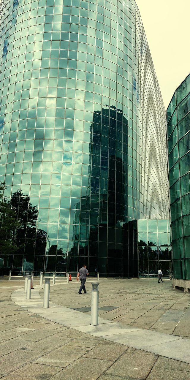 STREET BY MODERN BUILDINGS AGAINST SKY