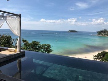 View of swimming pool by sea against sky