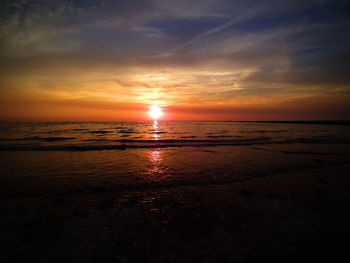 Scenic view of sea against romantic sky at sunset
