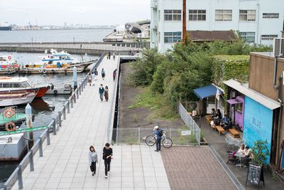 High angle view of people walking on footpath in city