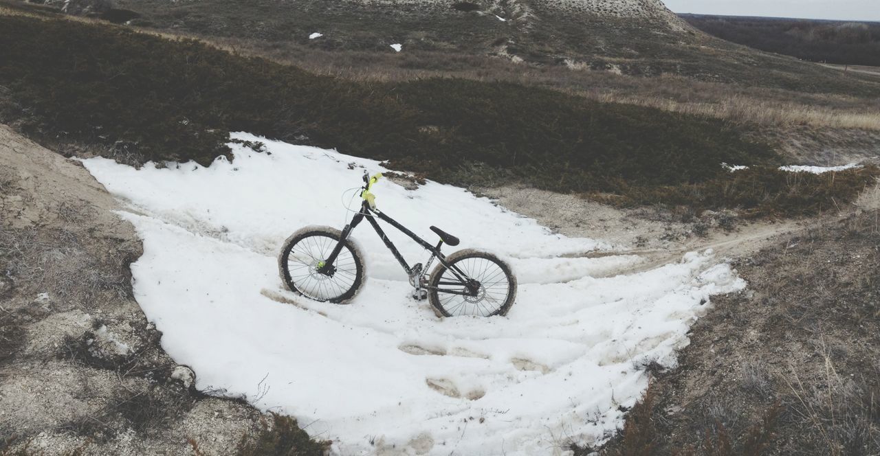 snow, transportation, winter, cold temperature, bicycle, high angle view, landscape, nature, mountain, land vehicle, day, mode of transport, tranquility, white color, field, beauty in nature, non-urban scene, outdoors, tranquil scene, scenics